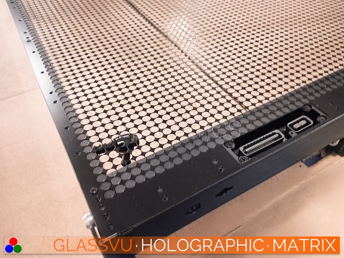 GlassVu Holographic Matrix high-transparency LED panel laid flat detailing the precision locking mechanisms and integrated data ports functioning as a seamlessly scalable see-through video wall.